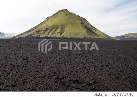 Maelifell volcano in black lava fields of Fjallabak Nature Reserve in Iceland. Maelifell volcano in black lava fields of Fjallabak Nature Reserve in Iceland. 107131446