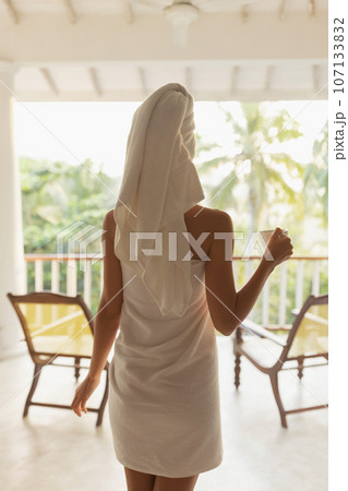 Thoughtful Woman With a Cup of Coffee After Shower on Resort Balcony 107133832