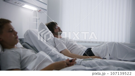 Patient talks with roommate and turns TV 107139522