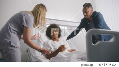 African American man visits son in medical center African American man visits son in medical center 107139562