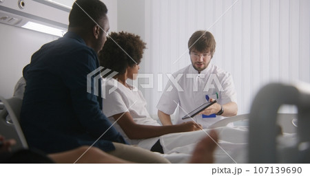 Doctor reports test results using tablet computer Doctor reports test results using tablet computer 107139690