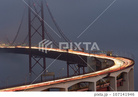 Blurred lights in motion from car headlights driving on a bridge in the evening 107141946