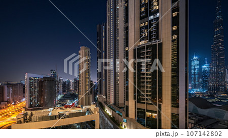 Tallest skyscrapers in downtown dubai located on bouleward street near shopping mall aerial night. 107142802