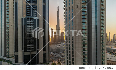 Tallest skyscrapers in downtown dubai located on bouleward street near shopping mall aerial all day. 107142803