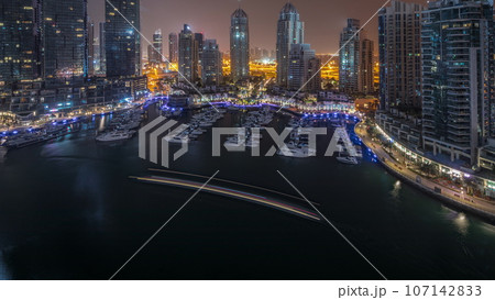 Luxury yacht bay in the city aerial all night in Dubai marina 107142833