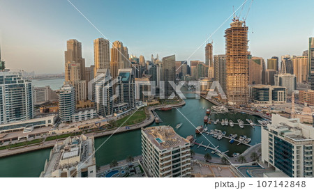 Panorama showing Dubai Marina skyscrapers and JBR district with luxury buildings and resorts aerial Panorama showing Dubai Marina skyscrapers and JBR district with luxury buildings and resorts aerial 107142848