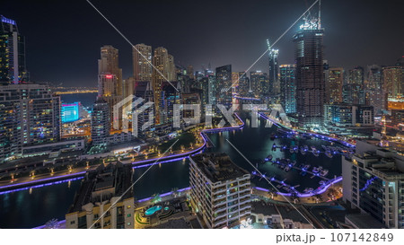 Panorama showing Dubai Marina skyscrapers and JBR district with luxury buildings and resorts aerial night 107142849