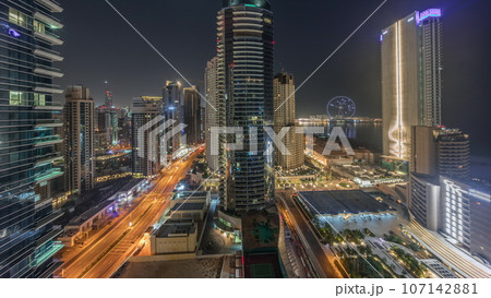 Panoramic view of the Dubai Marina and JBR area and the famous Ferris Wheel aerial night Panoramic view of the Dubai Marina and JBR area and the famous Ferris Wheel aerial night 107142881