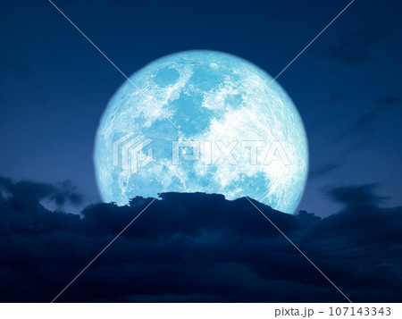 full harvest blue moon over dark heap cloud on night sky full harvest blue moon over dark heap cloud on night sky 107143343