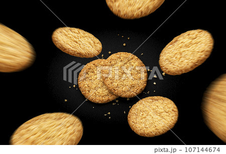 Flying oatmeal cookies on black background, top view 107144674