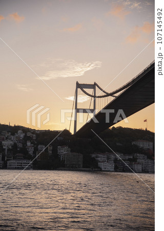 Bridge silhouette on background of sunset. Cityscape with sunset. Bottom view 107145492