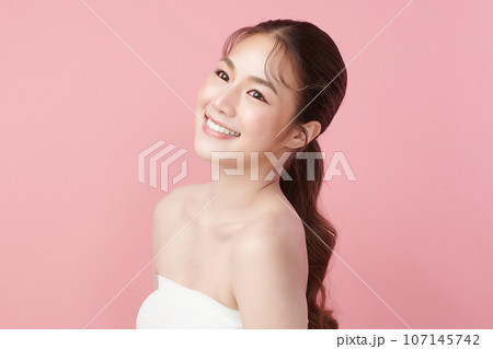 Beautiful smile of young woman with healthy white teeth on pink background, Dental care. Dentistry concept. 107145742