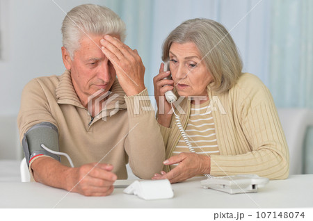 Portrait of senior couple measuring blood pressure together 107148074