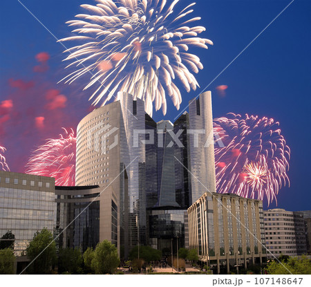 Celebratory fireworks over the Skyscrapers La Defense, commercial and business center of Paris, France 107148647