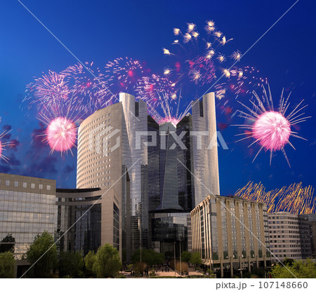 Celebratory fireworks over the Skyscrapers La Defense, commercial and business center of Paris, France 107148660