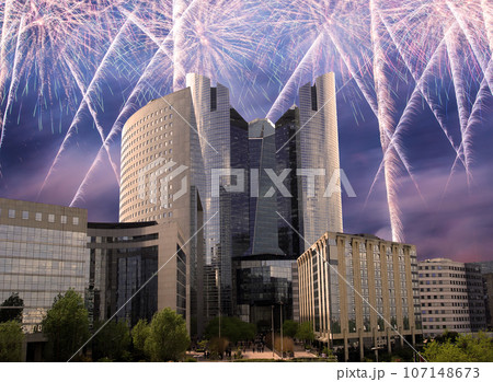 Celebratory fireworks over the Skyscrapers La Defense, commercial and business center of Paris, France 107148673