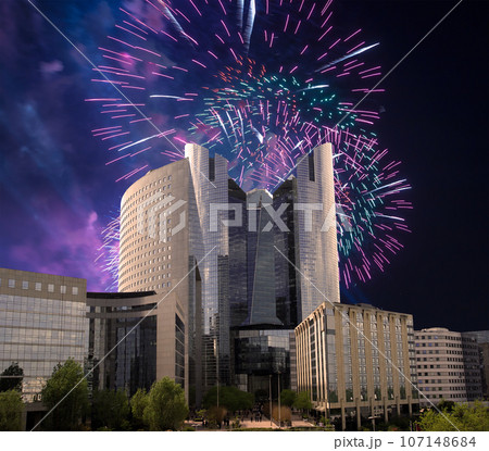 Celebratory fireworks over the Skyscrapers La Defense, commercial and business center of Paris, France 107148684