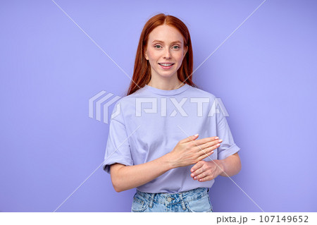 pleasant smiling redhead girl explaining something with hands pleasant smiling redhead girl explaining something with hands 107149652