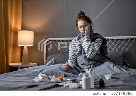 Sick, influenza Caucasian red-haired young woman having headache Sick, influenza Caucasian red-haired young woman having headache 107149860