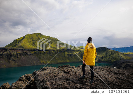 Backpacker girl admiring Blahylur lake in Iceland 107151361