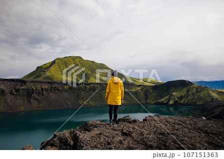 Backpacker girl contemplating the beauty of Blahylur lake in Iceland Backpacker girl contemplating the beauty of Blahylur lake in Iceland 107151363
