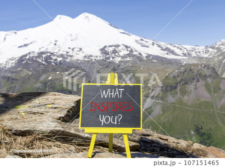 What inspires you symbol. Concept words What inspires you on beautiful black chalk blackboard. Beautiful mountain Elbrus background. Business motivational what inspires you concept. Copy space. 107151465