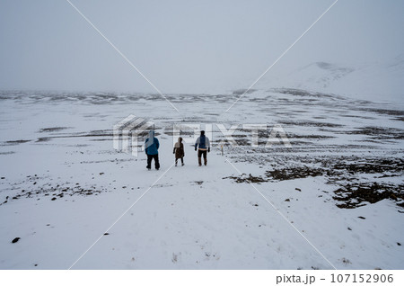 Three hikers on snow-covered trail to Askja Crater in northern Iceland. Three hikers on snow-covered trail to Askja Crater in northern Iceland. 107152906