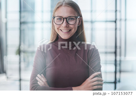 Front portrait of pretty young woman in office 107153077