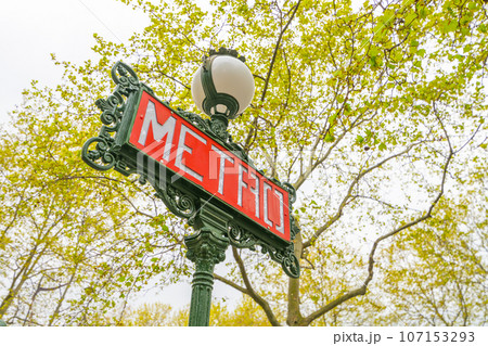 Red metro sign on the traditional green street lamp, Paris, France 107153293