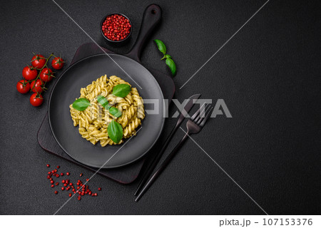 Delicious fresh pasta with green pesto sauce with basil 107153376
