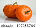 Pumpkins on white table against light wall for Halloween theme 107153709