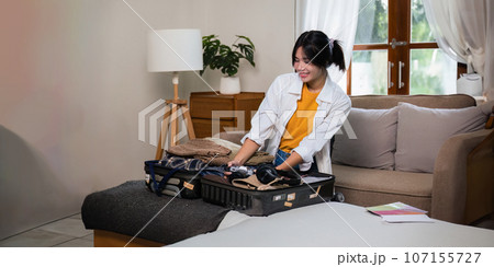 Young asian woman traveler pack bags prepare for the travel season vacation, concept lifestyle active journey and trip travel, passport 107155727