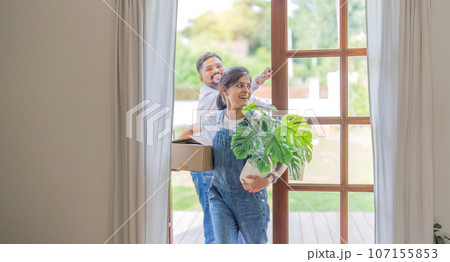 Indian young couple move the box into the home at new home. Relocation, moving to new home concept Indian young couple move the box into the home at new home. Relocation, moving to new home concept 107155853