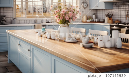 Interior of cozy vintage country style kitchen with kitchen island. Wooden countertops, light blue facades, various crockery, wildflowers in a vase. Contemporary home design. 107155929