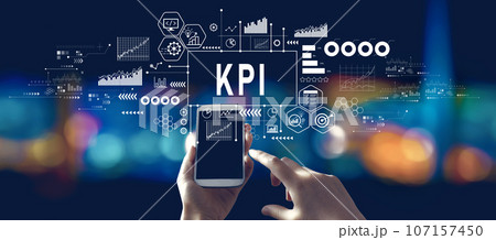 KPI - Key Performance Indicator theme with person using a smartphone at night KPI - Key Performance Indicator theme with person using a smartphone at night 107157450