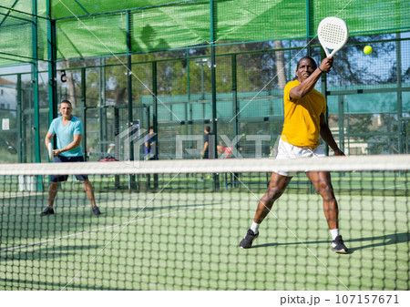 African american man padel tennis player trains on the court 107157671