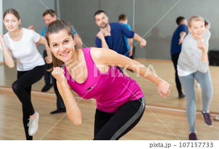 Young woman enjoying active dances Young woman enjoying active dances 107157733