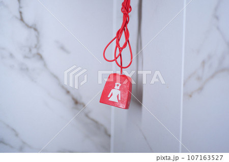 Red bathroom emergency pull cord in hospital. 107163527