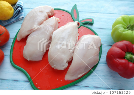 Chicken fillet with vegetables on a wooden board 107163529