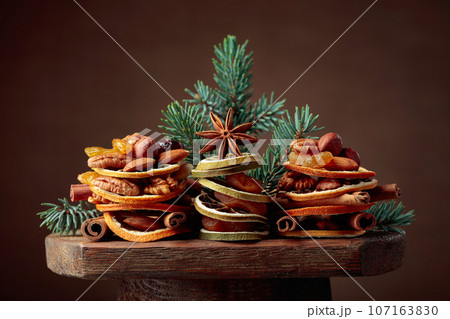 Christmas still-life with dried fruits and nuts. 107163830