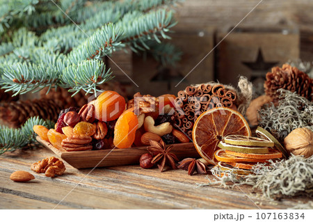 Christmas still-life with dried fruits and nuts. 107163834