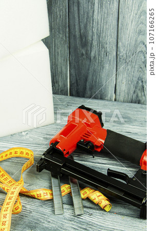 concept of furniture production and repair. Stapler and staples, working tool 107166265