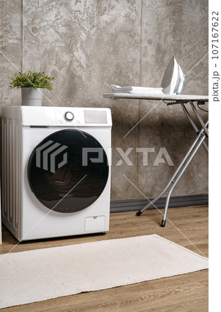 Cropped photos of bathroom interior with washing machine 107167622