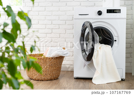 Modern white washing machine in a laundry room 107167769