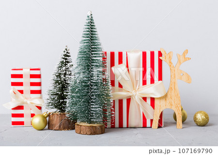 Christmas composition. craft Gift box, small tree, branches and craft DIY decorations on white background. New year concept. Christmas home decoration Flat lay, top view, copy space 107169790