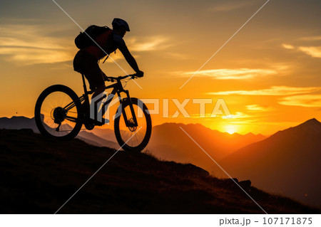 Silhouetted Mountain Biker at Dawn 107171875