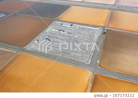 Aerial view of natural sea salt ponds, lake or sea. Farm field outdoor in traditional industry in Thailand. Asia culture. Agriculture irrigation. River reflection. 107173212
