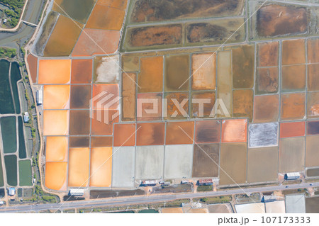Aerial view of natural sea salt ponds, lake or sea. Farm field outdoor in traditional industry in Thailand. Asia culture. Agriculture irrigation. River reflection. Aerial view of natural sea salt ponds, lake or sea. Farm field outdoor in traditional industry in Thailand. Asia culture. Agriculture irrigation. River reflection. 107173333