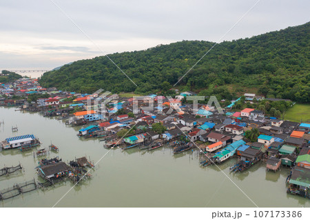 Aerial view of fishing trap net in canel with fisherman urban city village town houses, lake or river. Nature landscape fisheries and fishing tools at Pak Pha, Songkhla, Thailand. Aquaculture farming Aerial view of fishing trap net in canel with fisherman urban city village town houses, lake or river. Nature landscape fisheries and fishing tools at Pak Pha, Songkhla, Thailand. Aquaculture farming 107173386