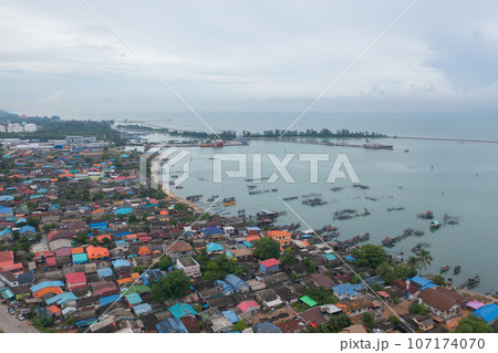 Aerial view of fishing trap net in canel with fisherman urban city village town houses, lake or river. Nature landscape fisheries and fishing tools at Pak Pha, Songkhla, Thailand. Aquaculture farming Aerial view of fishing trap net in canel with fisherman urban city village town houses, lake or river. Nature landscape fisheries and fishing tools at Pak Pha, Songkhla, Thailand. Aquaculture farming 107174070